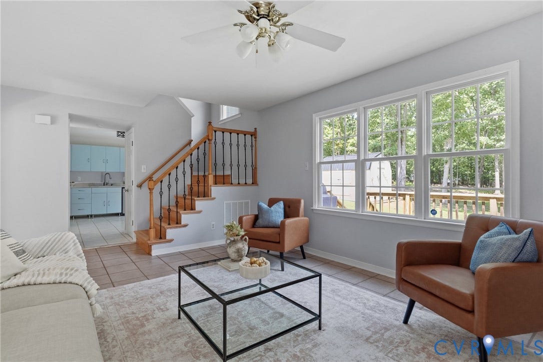 3242 Sherwood Ridge Drive, Powhatan, VA 23139 Three large windows, wood staircase with black iron spindles, tile flooring, and a ceiling fan
