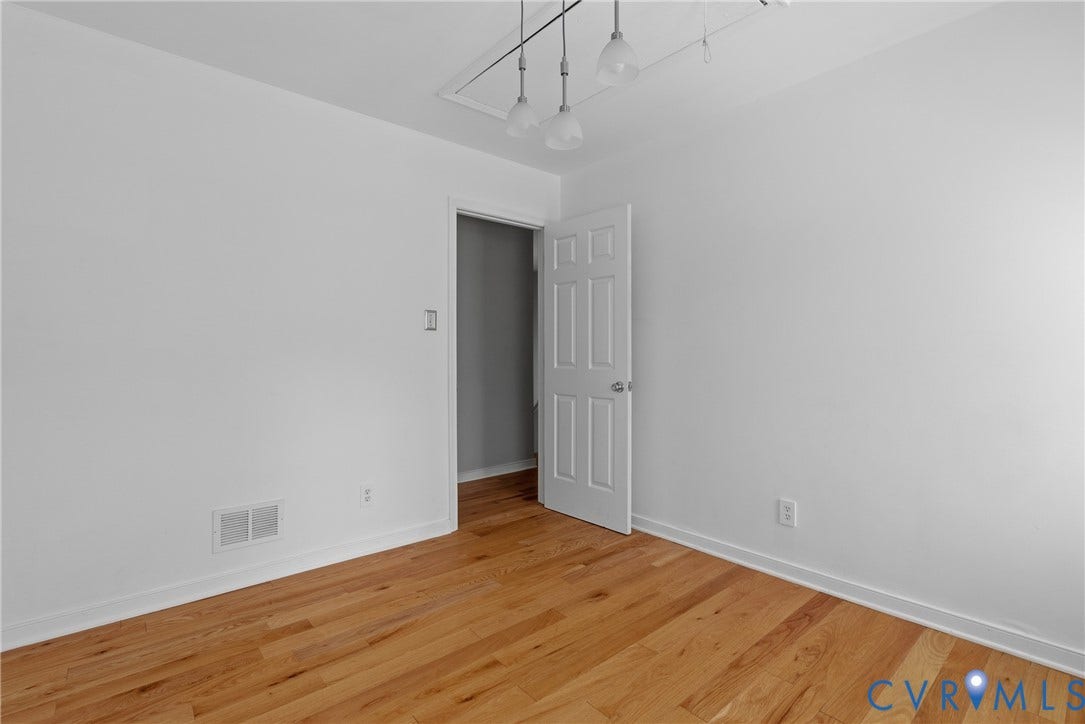 3242 Sherwood Ridge Drive, Powhatan, VA 23139 Hardwood flooring, painted white walls, white trim, track lighting, and a paneled door