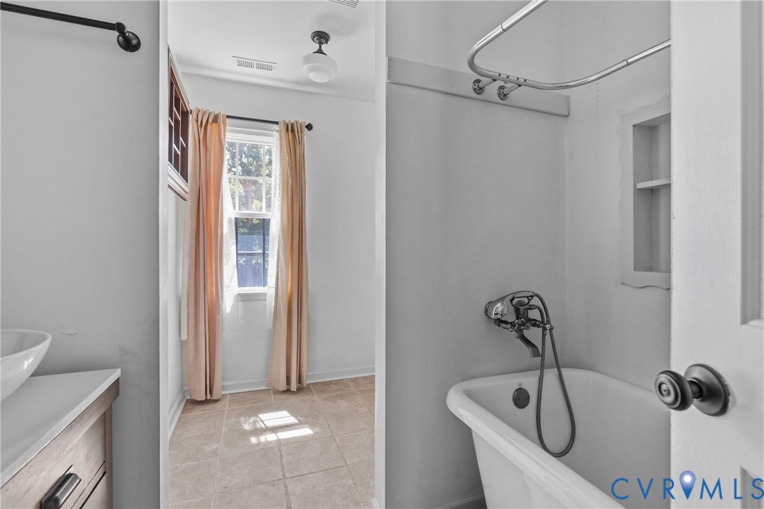 3242 Sherwood Ridge Drive, Powhatan, VA 23139 Pedestal sink with a bowl basin, tiled flooring, built-in shelving, classic clawfoot tub, and a single window
