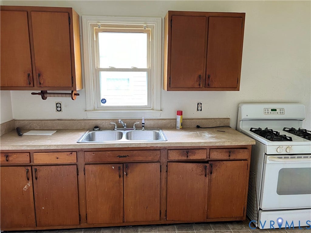5429 Blueridge Avenue, Fulton, Richmond, VA 23231 Kitchen featuring wood-finish cabinetry, a double basin stainless steel sink, and a white freestanding range