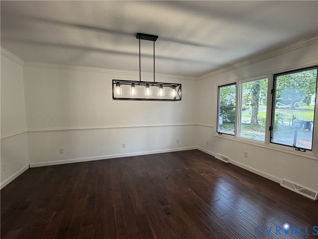 4603 Edenton Place, Greenbriar, Chester, VA 23831 Hardwood flooring, crown molding, chair rail molding, contemporary linear chandelier, and ample natural light from multiple windows