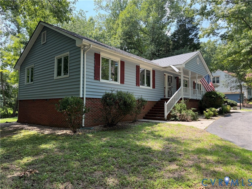4603 Edenton Place, Greenbriar, Chester, VA 23831 Light blue siding exterior with a partial brick foundation, white trim, red window shutters, and a covered porch