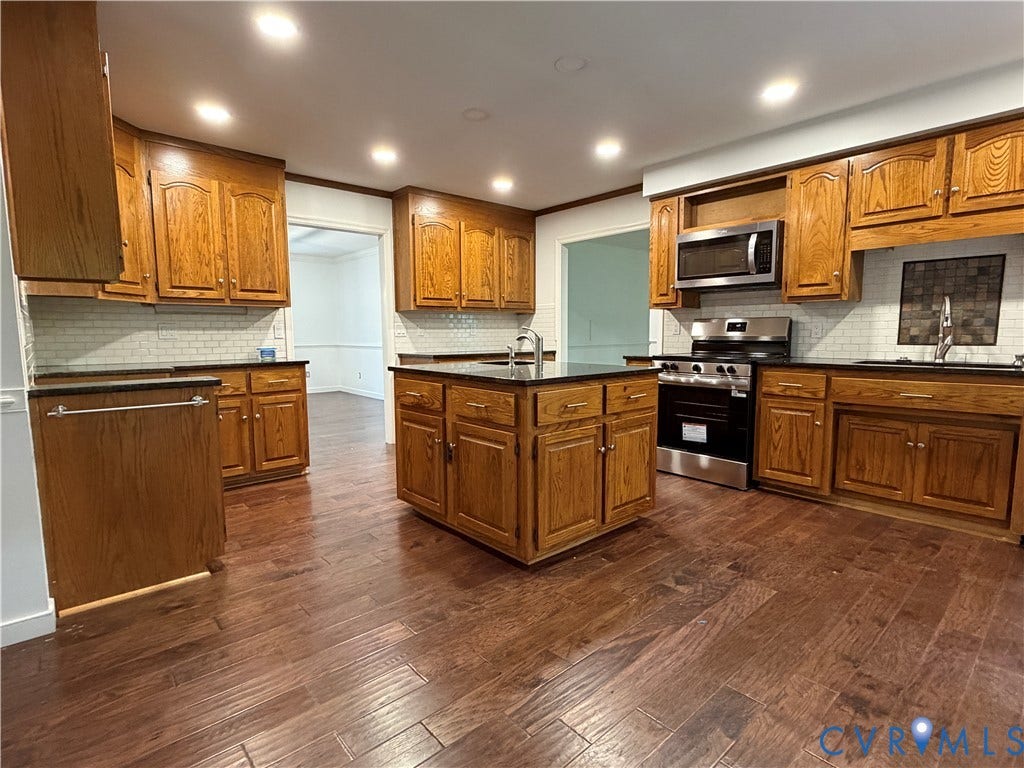 4603 Edenton Place, Greenbriar, Chester, VA 23831 Kitchen featuring wood-finish flooring, recessed lighting, wood cabinetry, dark countertops, and stainless steel appliances