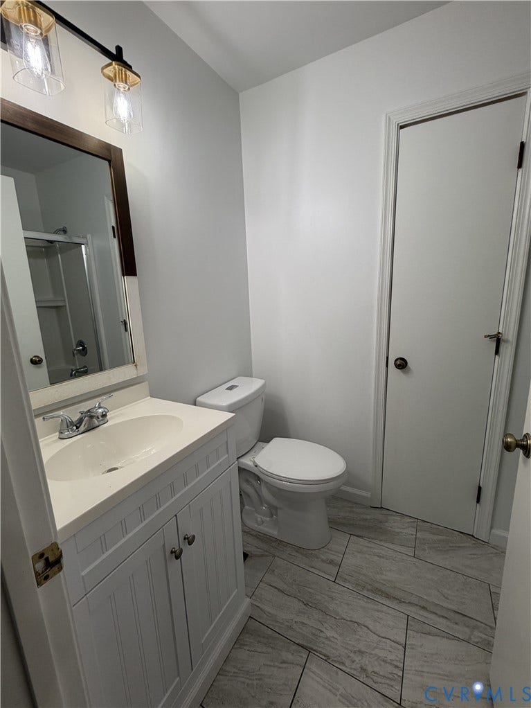 4603 Edenton Place, Greenbriar, Chester, VA 23831 White vanity with an integrated sink, polished chrome faucet, and a rectangular framed mirror
