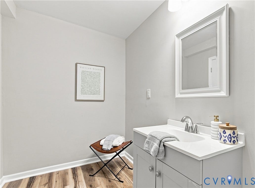 16111 Walkers Mill Road, Stony Creek, VA 23832 Vanity with integrated sink, chrome faucet, and framed mirror