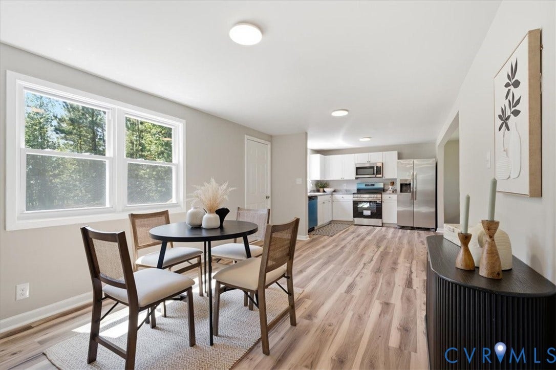 16111 Walkers Mill Road, Stony Creek, VA 23832 Open-concept kitchen and dining area featuring wood-finish flooring, white cabinetry, stainless steel appliances, and ample natural light
