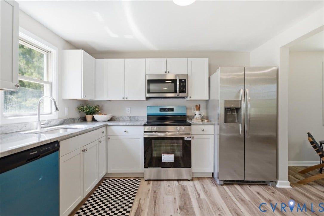 16111 Walkers Mill Road, Stony Creek, VA 23832 Kitchen featuring white cabinetry, light-toned countertops, stainless steel appliances, and wood-finish flooring