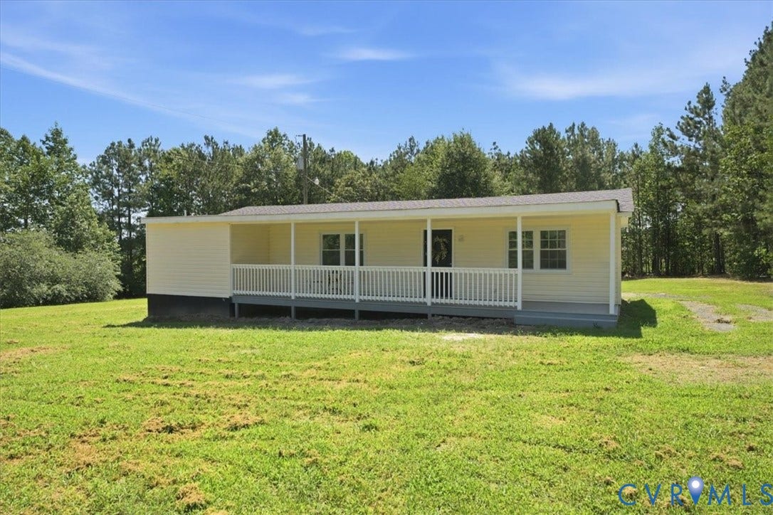 16111 Walkers Mill Road, Stony Creek, VA 23832 Front porch with white railings, light yellow siding exterior, and a light gray roof