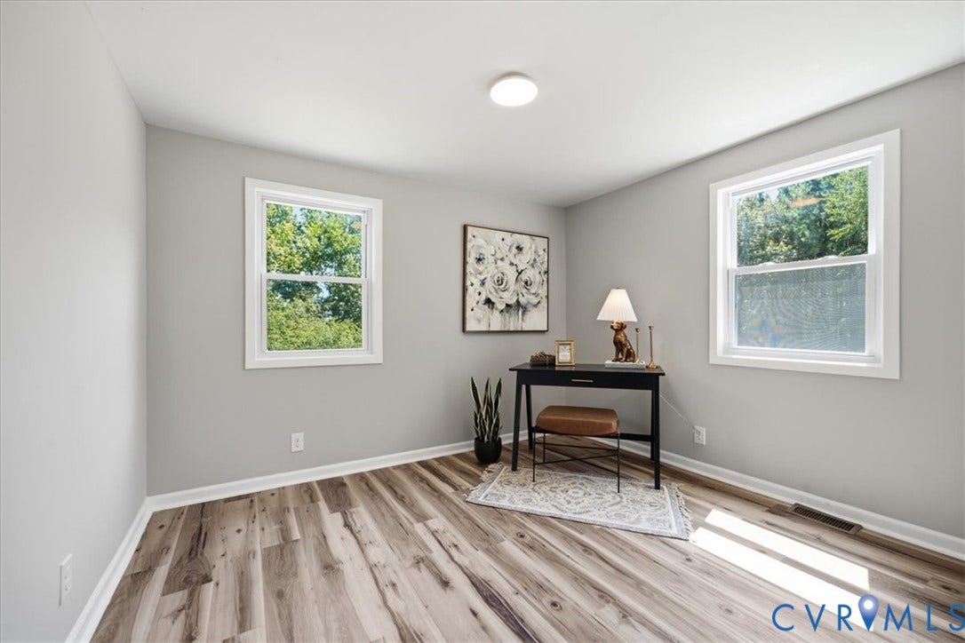 16111 Walkers Mill Road, Stony Creek, VA 23832 Bright, light-filled room with dual casement windows featuring white frames, recessed ceiling lighting, and wide-plank wood-finish flooring