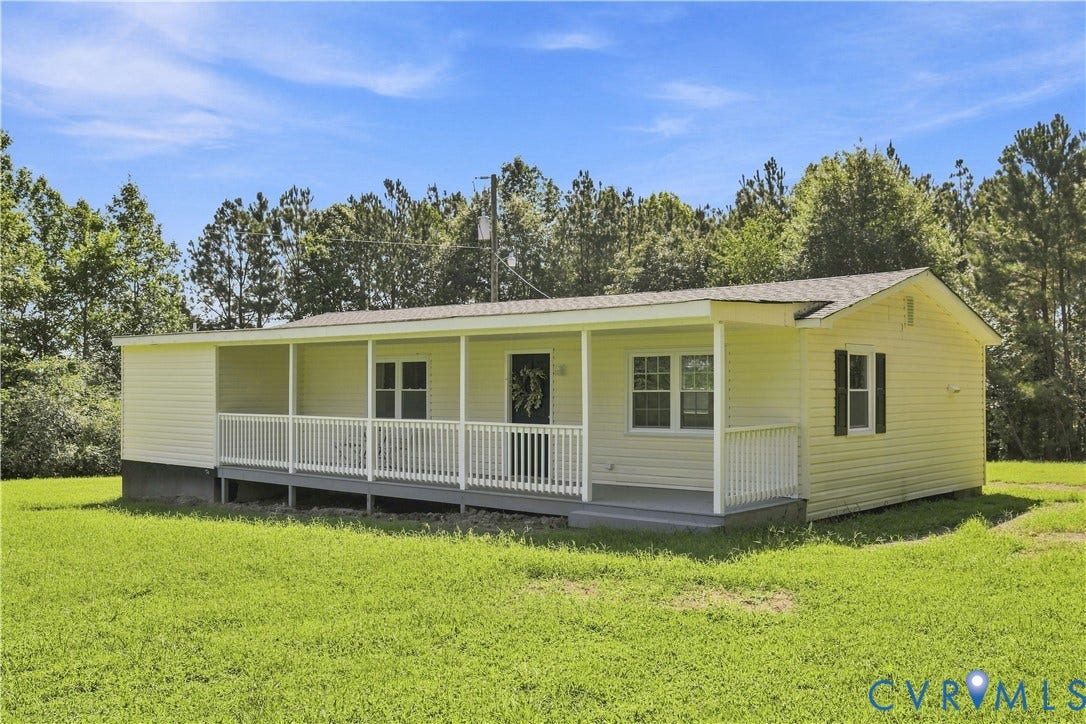 16111 Walkers Mill Road, Stony Creek, VA 23832 Single-story residence with light-colored siding, a covered front porch, and a white railing