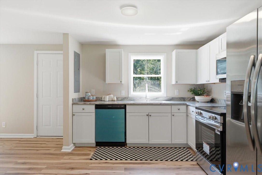 16111 Walkers Mill Road, Stony Creek, VA 23832 Kitchen featuring white cabinetry, light-toned wood-finish flooring, stainless steel appliances, and a window above the sink