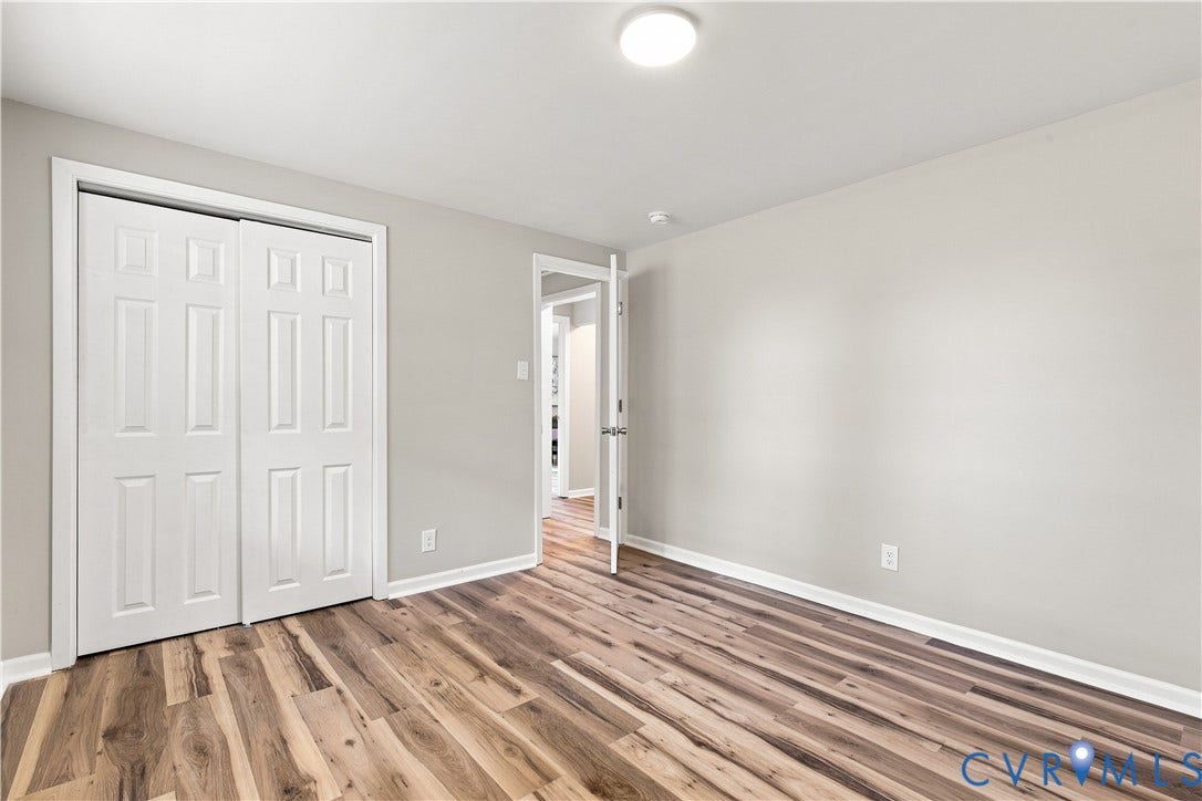 16111 Walkers Mill Road, Stony Creek, VA 23832 Wood-finish flooring, white bi-fold closet doors, painted walls, and overhead flush-mount lighting
