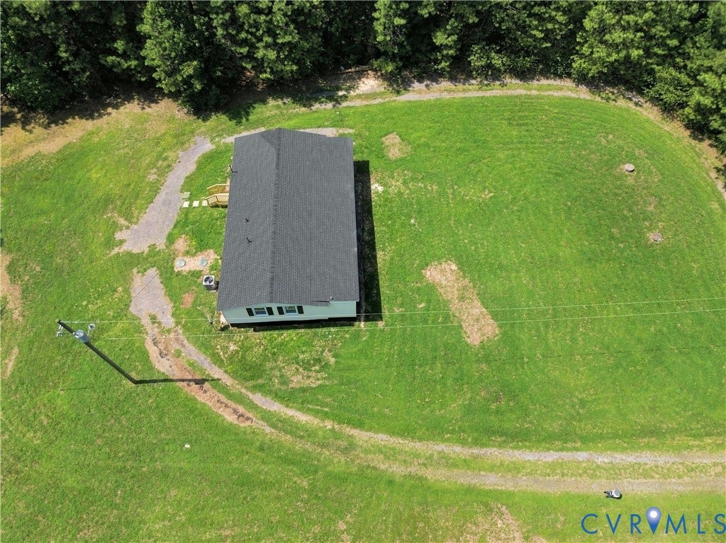 16111 Walkers Mill Road, Stony Creek, VA 23832 Expansive grassy lot, surrounded by mature trees, features a single-story residence with a dark shingle roof and light-colored siding