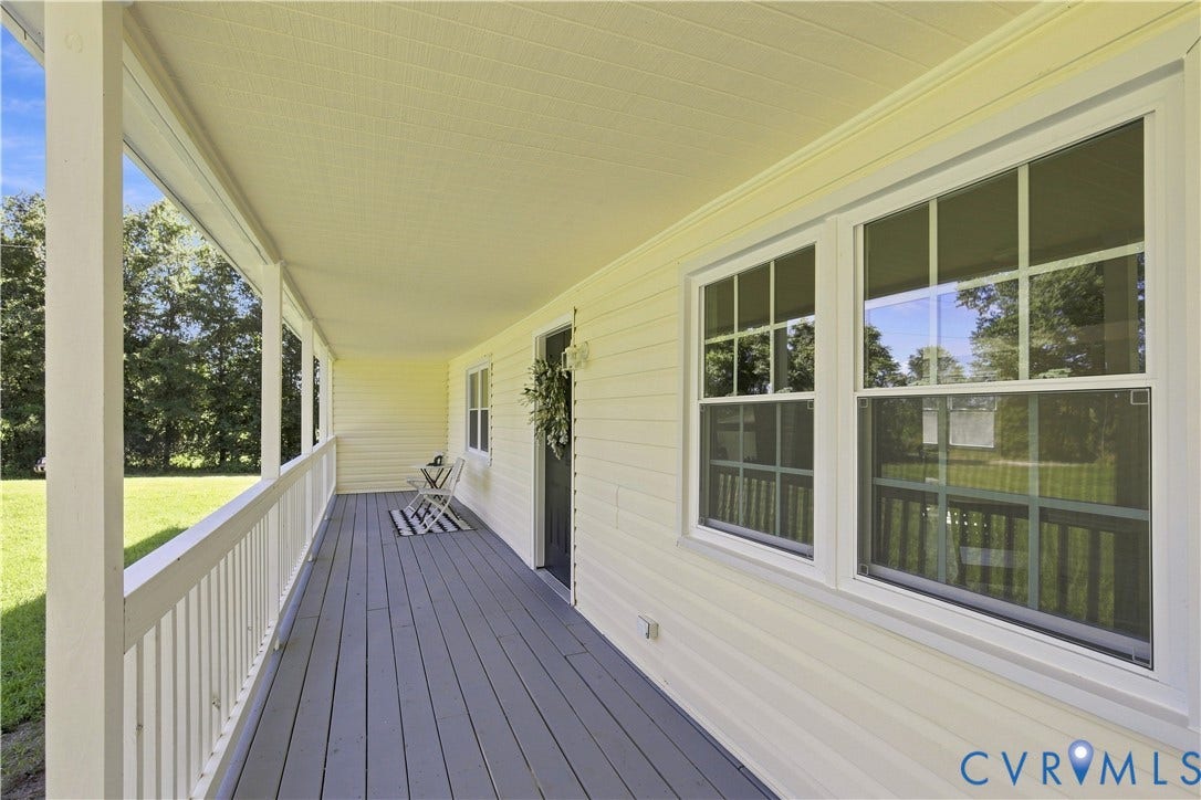 16111 Walkers Mill Road, Stony Creek, VA 23832 Expansive covered porch with a painted wood floor, white railing, and multiple windows
