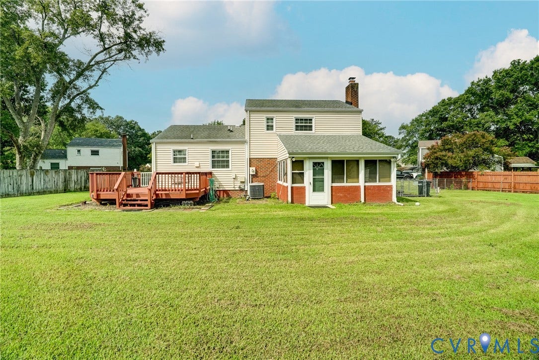 10104 Terry Court, Henrico, VA 23228 Expansive rear yard featuring a large wood deck, attached screened porch, brick accents, and vinyl siding