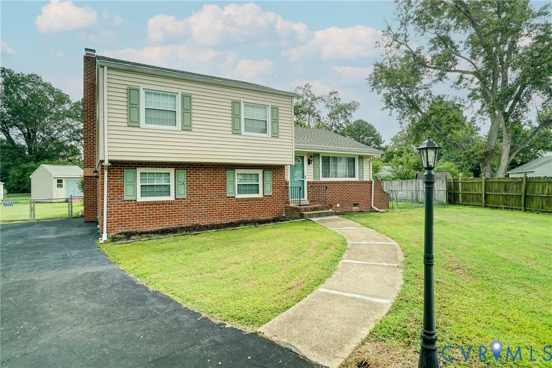 10104 Terry Court, Henrico, VA 23228 Two-story exterior with brick and siding, featuring a curved concrete walkway, paved driveway, and established lawn