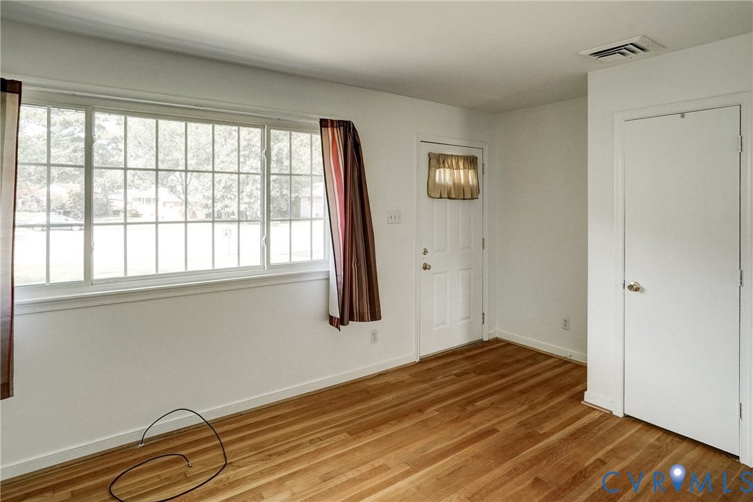 10104 Terry Court, Henrico, VA 23228 Hardwood-finish flooring, white painted walls, large multi-pane window, white paneled door, built-in closet