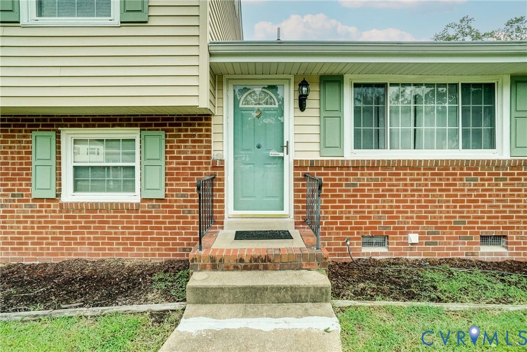10104 Terry Court, Henrico, VA 23228 Brick and siding exterior with a light green front door, coordinating shutters, and a concrete pathway