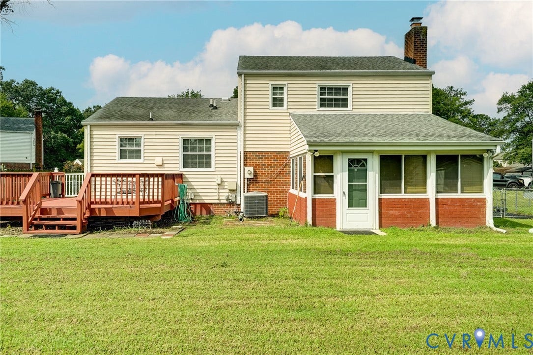 10104 Terry Court, Henrico, VA 23228 Expansive lawn featuring a multi-level wood deck, a sunroom with brick siding, and a white storm door