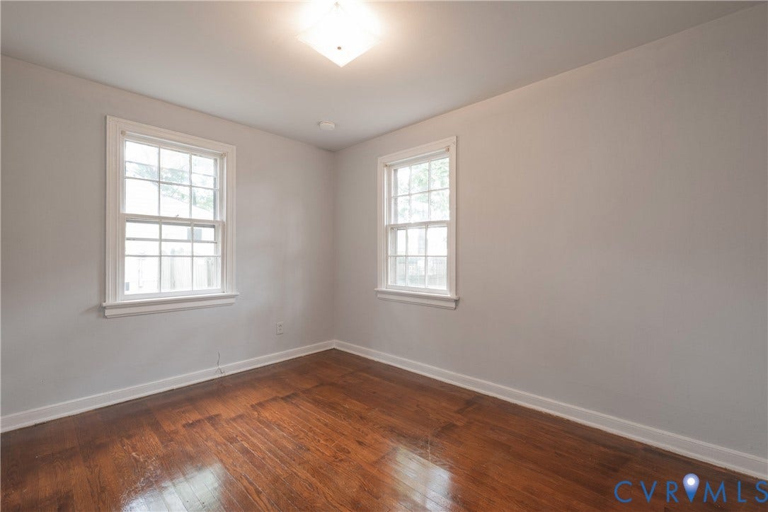 1704 Westhill Road, Richmond, VA 23226 Bedroom #2 Hardwood flooring, light gray wall finish, two double-hung windows with white trim, and a flush mount ceiling light fixture