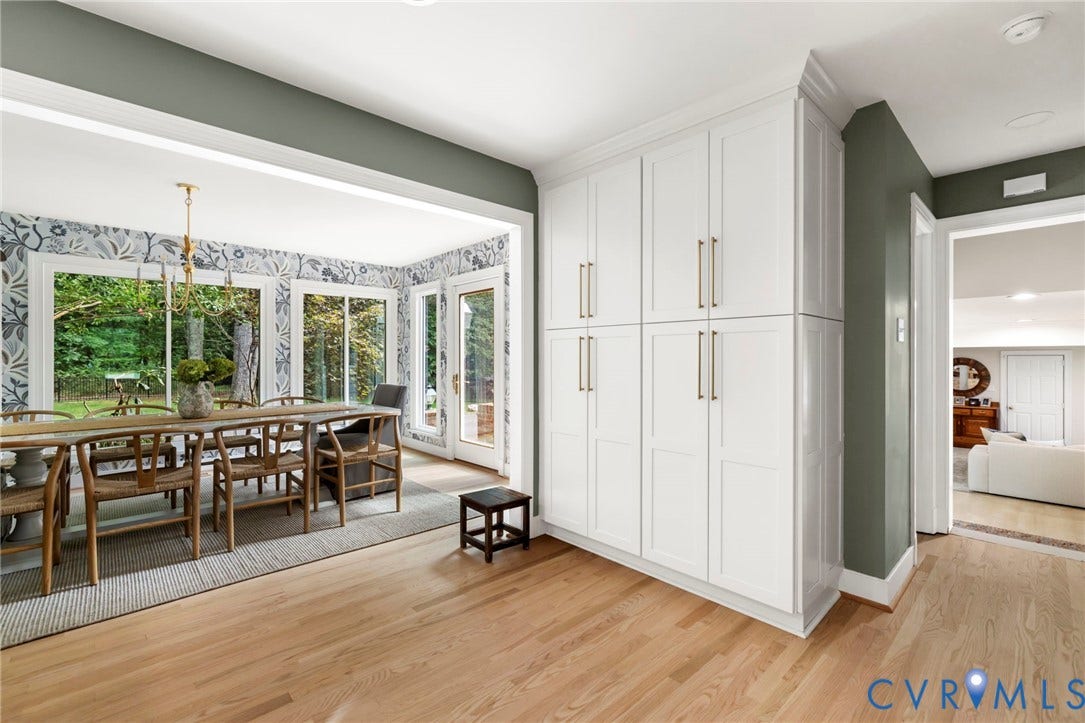 13531 W Salisbury Road, Salisbury, Midlothian, VA 23113 Built-in white cabinetry with gold-tone hardware, light wood-finish flooring, and a dining area featuring large windows and a glass-paneled door