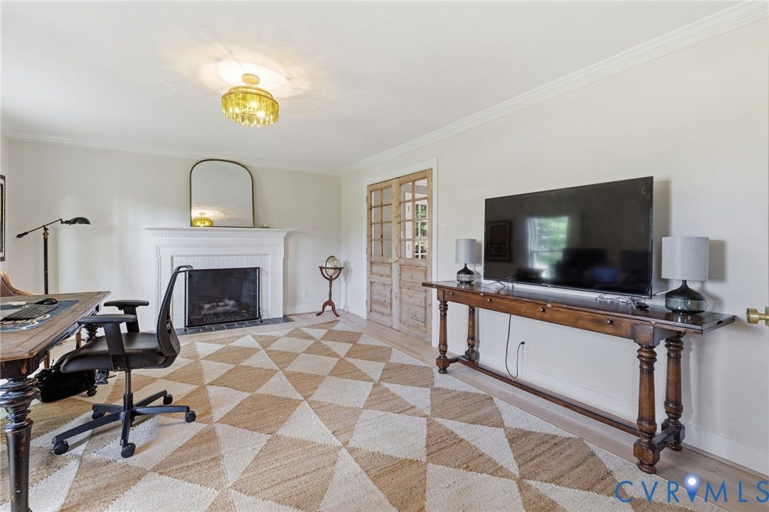 13531 W Salisbury Road, Salisbury, Midlothian, VA 23113 Fireplace with a classic white mantel, decorative ceiling light fixture, crown molding, and light wood-finish flooring