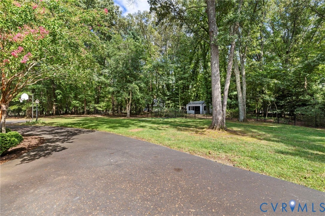 13531 W Salisbury Road, Salisbury, Midlothian, VA 23113 Expansive landscaped yard with mature trees, a detached storage building, and black metal fencing