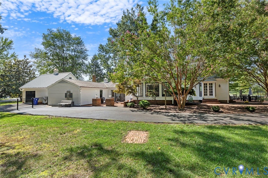 13531 W Salisbury Road, Salisbury, Midlothian, VA 23113 Expansive paved driveway, mature trees, white siding, metal roof, and a brick patio