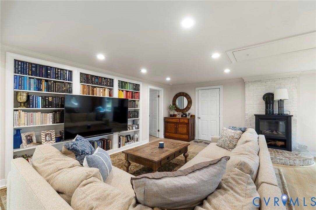 13531 W Salisbury Road, Salisbury, Midlothian, VA 23113 Built-in shelving, recessed lighting, and a fireplace with a brick surround