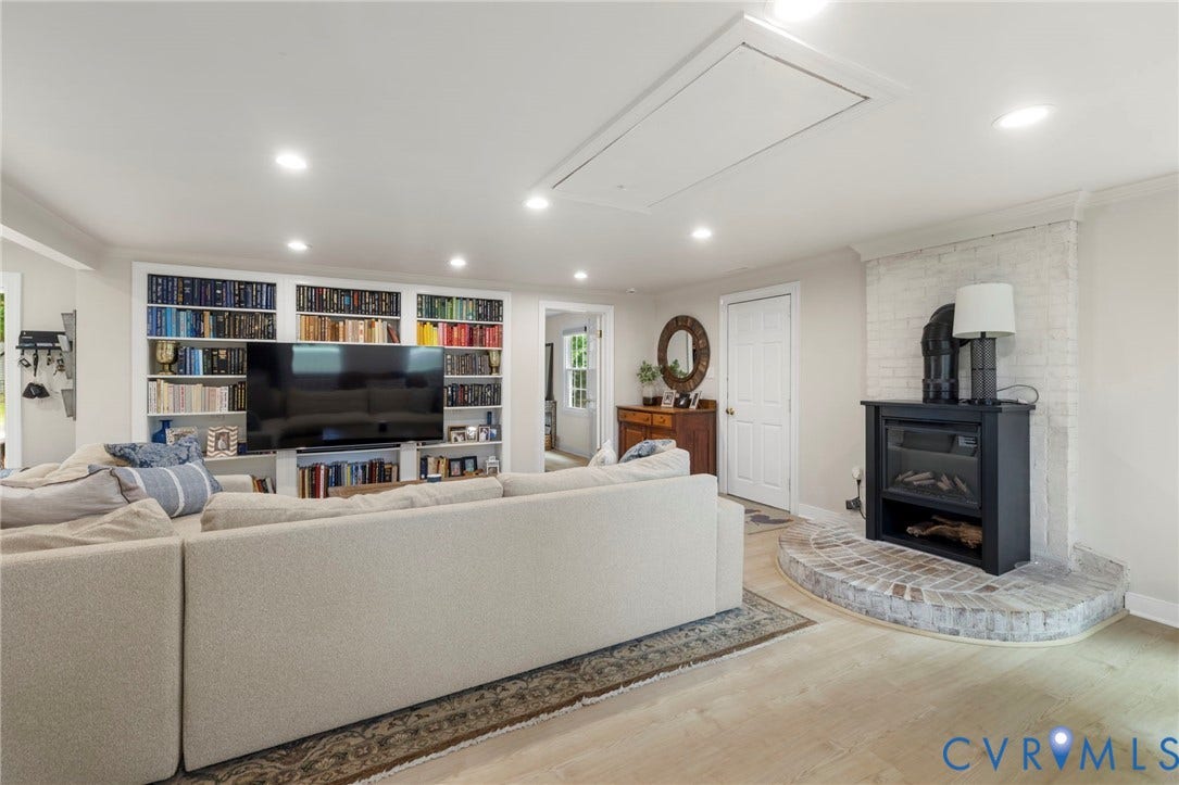 13531 W Salisbury Road, Salisbury, Midlothian, VA 23113 Built-in entertainment center with shelving, wood-finish flooring, recessed lighting, and a painted brick fireplace