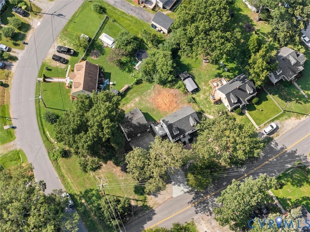 4818 Castlewood Road, Richmond, VA 23234 Aerial view showcasing a residential property nestled on a generous lot with mature landscaping, multiple trees providing natural privacy, and a curved driveway