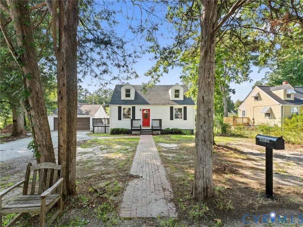 4818 Castlewood Road, Richmond, VA 23234 White exterior with black shutters, red front door, and dormer windows