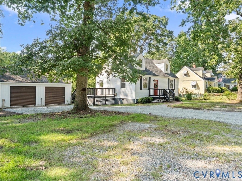 4818 Castlewood Road, Richmond, VA 23234 White siding exterior with a dark trim deck and a gravel driveway