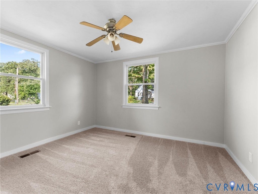4818 Castlewood Road, Richmond, VA 23234 Recessed lighting, ceiling fan with light fixture, two double-hung windows, crown molding, and neutral carpet