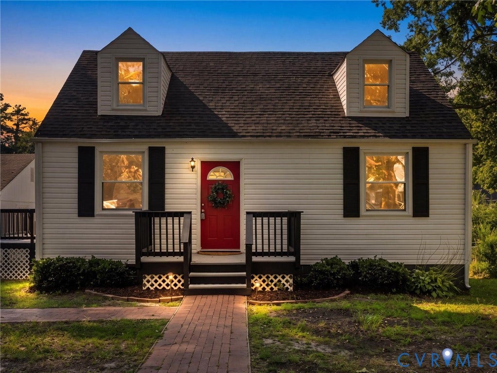 4818 Castlewood Road, Richmond, VA 23234 White siding exterior with a dark shingle roof and two dormer windows