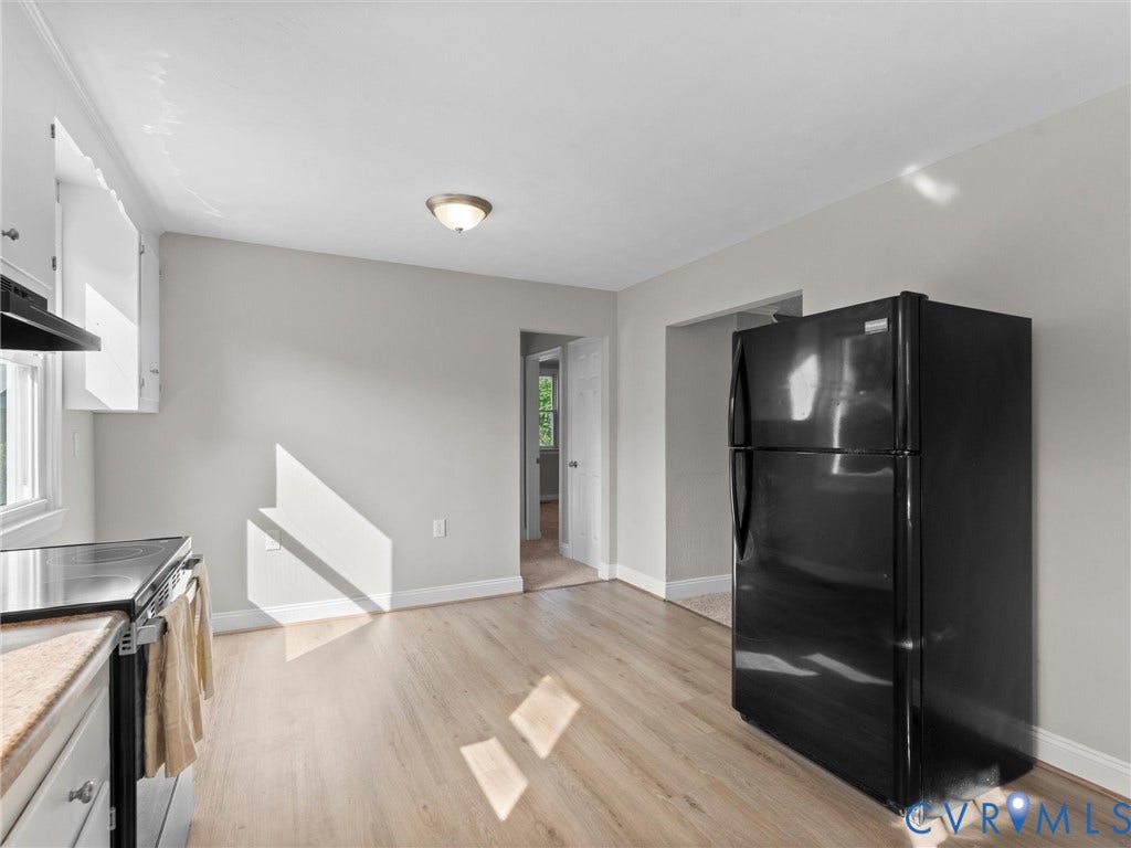 4818 Castlewood Road, Richmond, VA 23234 Light wood-finish flooring, white walls, built-in white cabinetry, and a ceiling-mounted light fixture