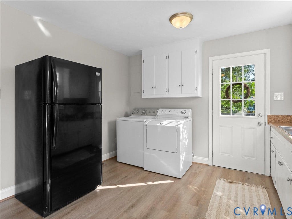 4818 Castlewood Road, Richmond, VA 23234 White upper and lower cabinetry, wood-finish flooring, and a white paneled door with glass inserts