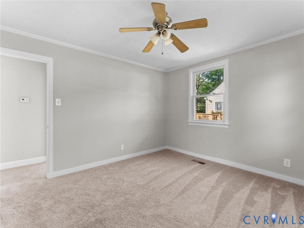 4818 Castlewood Road, Richmond, VA 23234 Bright, neutral bedroom featuring neutral carpeting, a ceiling fan with wood-finish blades, and abundant natural light from a large window