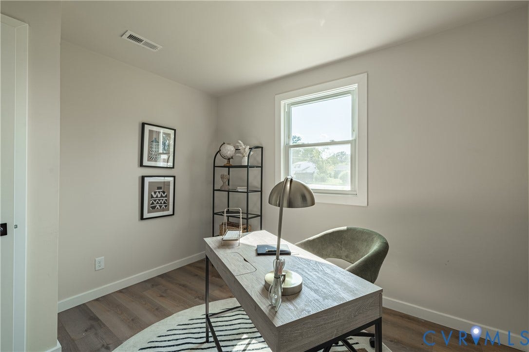 Neutral painted walls, single-pane window, wood-finish flooring, and white trim