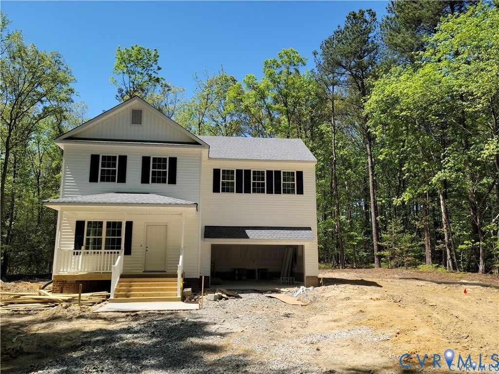Lot 313 Shenandoah Crossing Drive, Gordonsville, VA 22942 Two-story residence featuring white siding and dark shutters, an attached garage, a covered front porch with white railings, and a prominent gable roofline