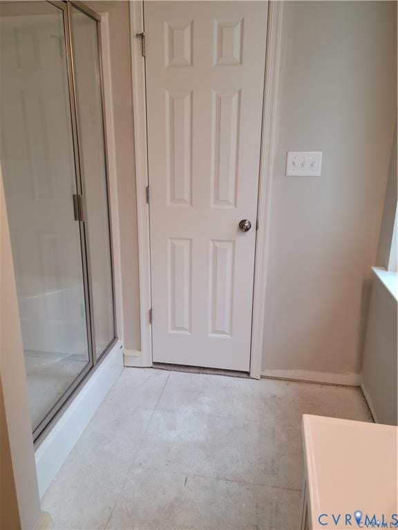 Lot 313 Shenandoah Crossing Drive, Gordonsville, VA 22942 Glass shower enclosure with chrome hardware, six-panel interior door, wall-mounted light switch, and light-toned tile flooring