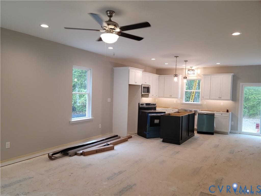 Lot 313 Shenandoah Crossing Drive, Gordonsville, VA 22942 Open-concept kitchen with white shaker cabinetry, stainless steel appliances, and a dark-toned island