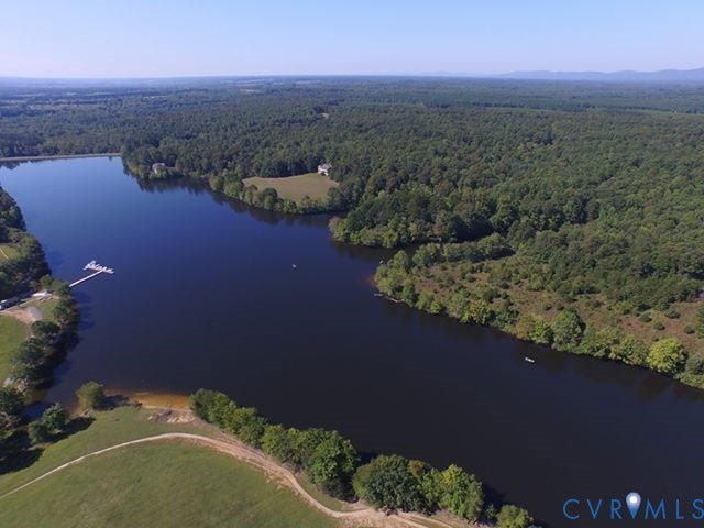 Lot 320 Bay Hill Road, Gordonsville, VA 22942 Expansive waterfront property featuring a private dock, surrounded by mature trees and open green spaces