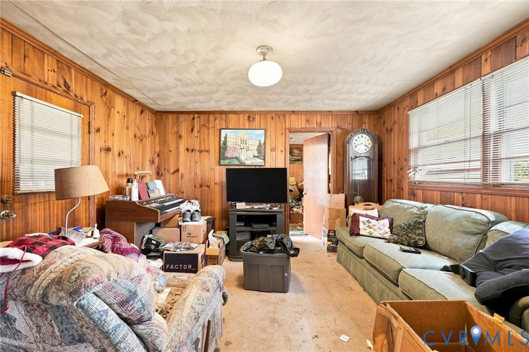 1904 Fon Du Lac Road, Henrico, VA 23229 Warm wood-paneled living space with carpeted flooring, ceiling-mounted light fixture, and built-in entertainment setup