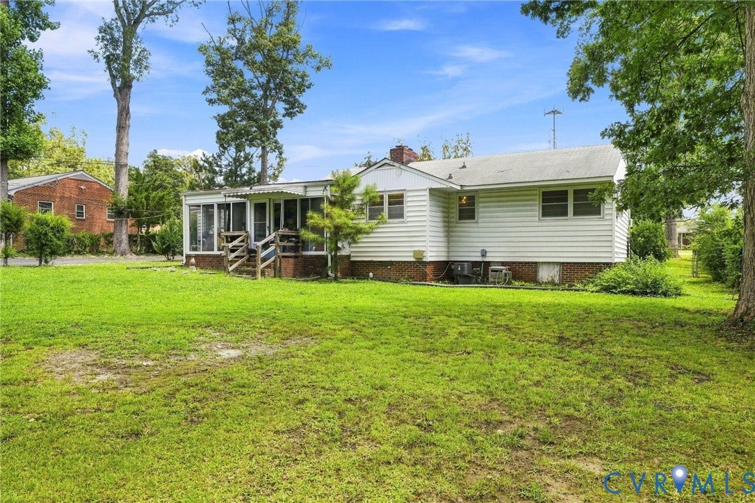 1904 Fon Du Lac Road, Henrico, VA 23229 Expansive rear yard with a bright sunroom addition, white siding, and mature perimeter trees