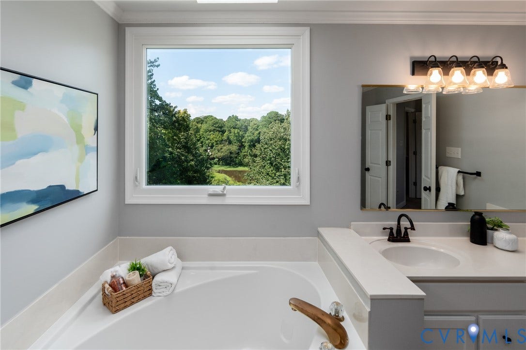 Garden tub with brass-tone fixtures