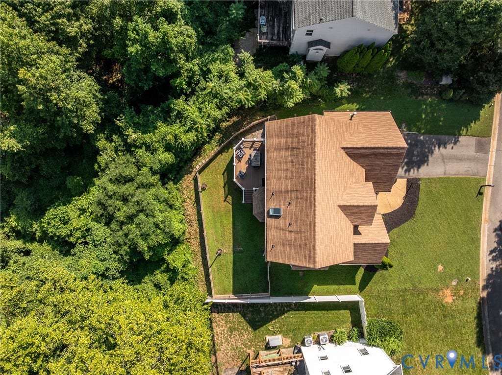 Wood-shingle roof, wood deck, white picket fence, retaining wall, and manicured lawn