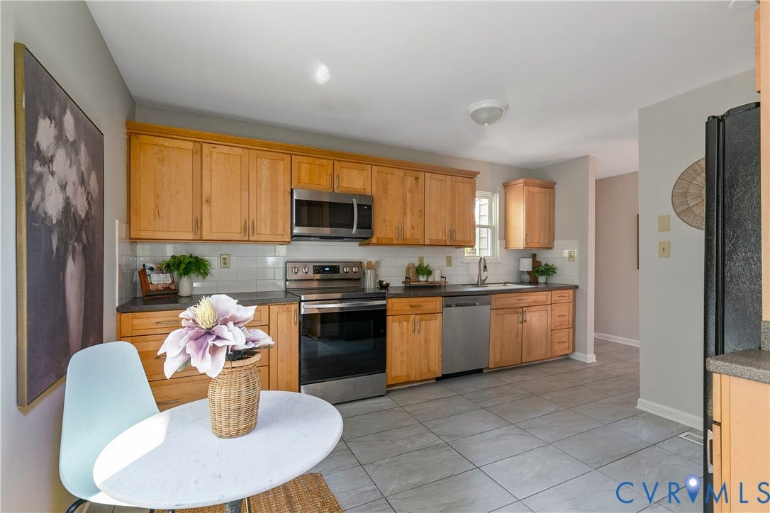 928 Marblethorpe Road, North Chesterfield, VA 23236 The large kitchen features maple cabinets and tile backsplash and floors.