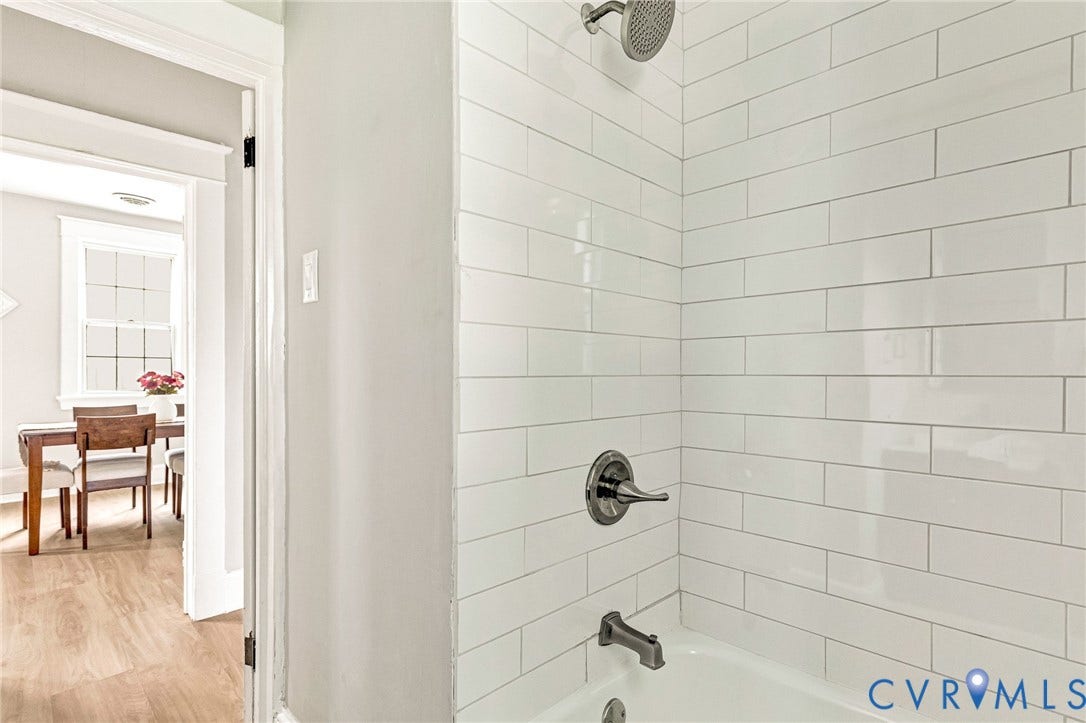 403 Masonic Lane, Masonic, Henrico, VA 23223 Spa-inspired shower featuring subway tile walls with contrasting grout lines, chrome shower fixtures, and rainfall showerhead