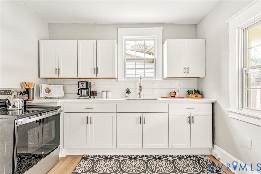 403 Masonic Lane, Masonic, Henrico, VA 23223 White shaker-style cabinetry with matte black hardware, white subway tile backsplash, white countertops, stainless steel electric range, and wood-finish flooring